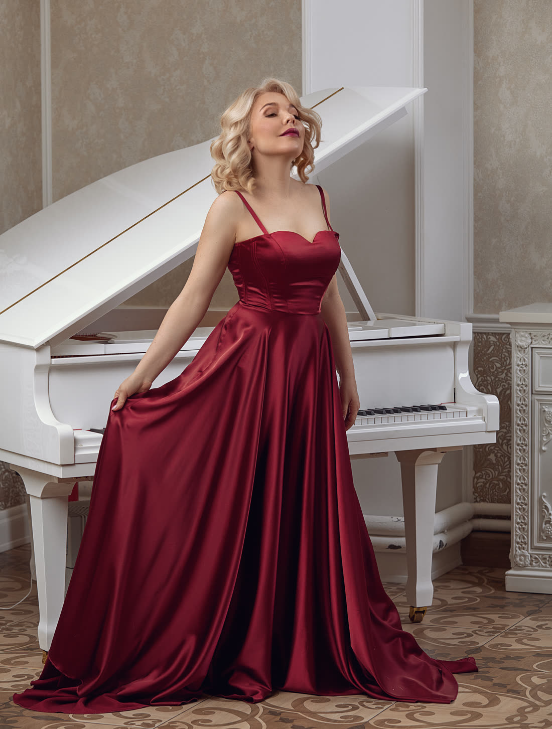 Dr. Maria Pisarenko, concert pianist, at a white grand piano — available for weddings and events in Las Vegas